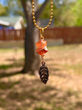 Load image into Gallery viewer, Crystal Swirl & Feather Guardian – Tangerine Aura Quartz Necklace | Wire Wrapped Pendant for Joy & Creative Energy