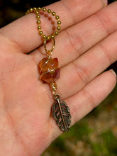 Load image into Gallery viewer, Crystal Swirl & Feather Guardian – Tangerine Aura Quartz Necklace | Wire Wrapped Pendant for Joy & Creative Energy