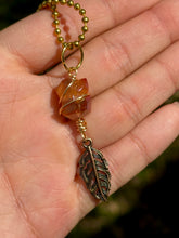 Load image into Gallery viewer, Crystal Swirl &amp; Feather Guardian – Tangerine Aura Quartz Necklace | Wire Wrapped Pendant for Joy &amp; Creative Energy
