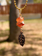 Load image into Gallery viewer, Crystal Swirl &amp; Feather Guardian – Tangerine Aura Quartz Necklace | Wire Wrapped Pendant for Joy &amp; Creative Energy
